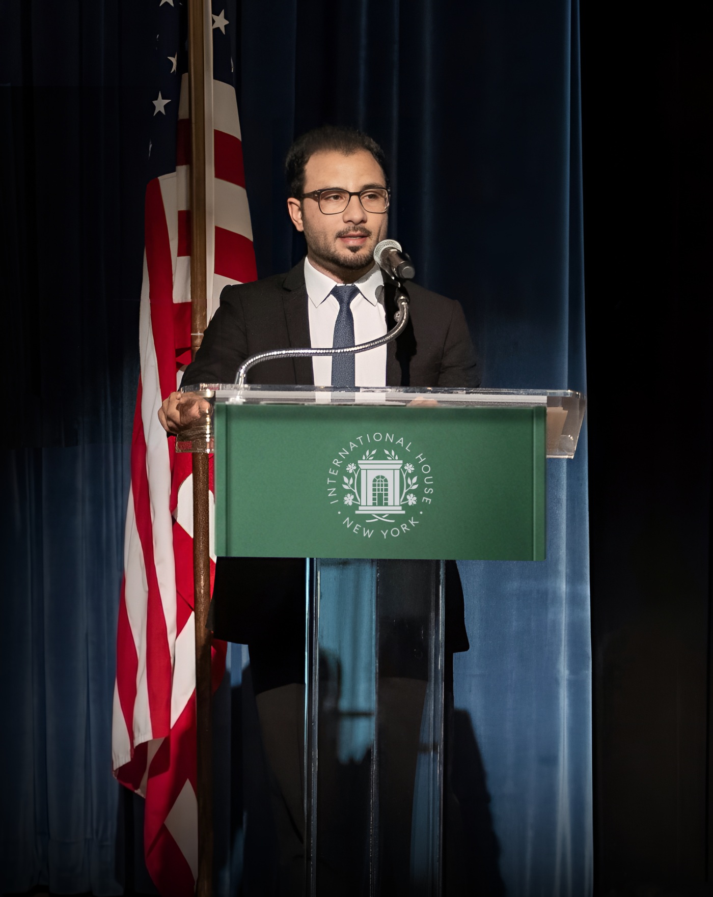 Yahya Qanie speaking at a podium
